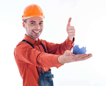 A builder man holding  a paper house.