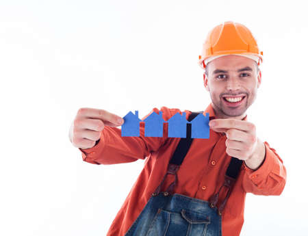 A builder man holding  paper houses.の写真素材