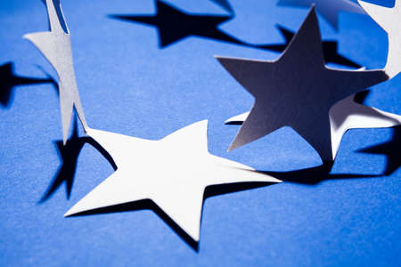 Paper christmas stars on the blue background .の写真素材