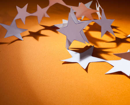 Paper christmas stars on the  yellow  background .の写真素材