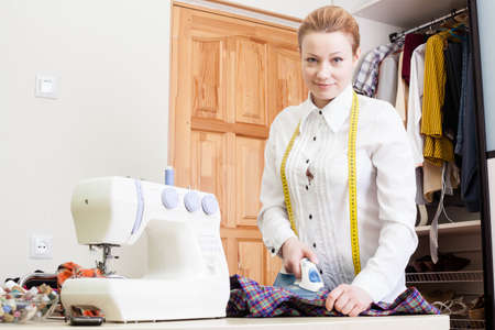 A sewer ironing a garment.の写真素材