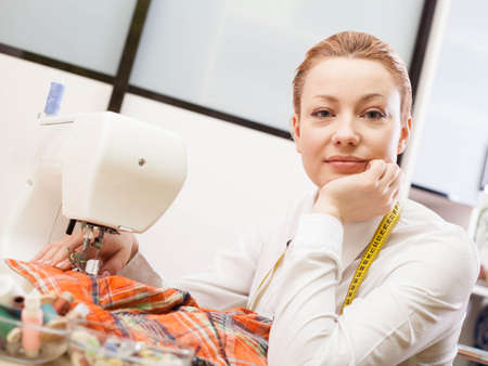A sewer working on the sewing machine.