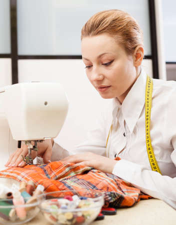 A sewer working on the sewing machine.