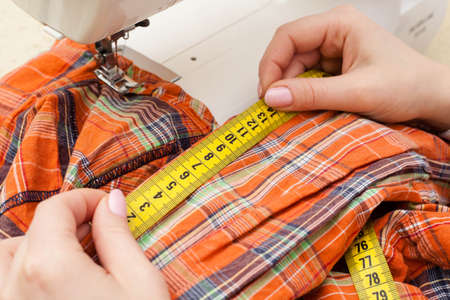 A sewer measuring a garment.の写真素材