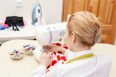 A sewer working on the sewing machine.の写真素材