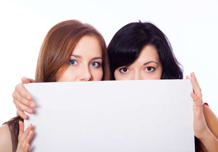 Two young girls with a banner on the white background.の写真素材