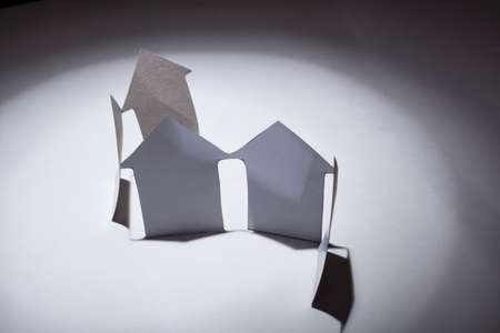 Cutout paper houses linked together  の写真素材