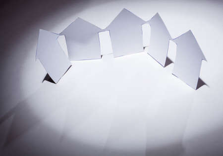 Cutout paper houses linked together  