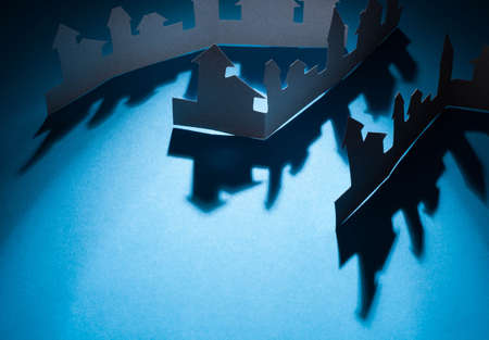 Cutout paper houses linked together  