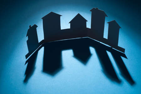 Cutout paper houses linked together  の写真素材