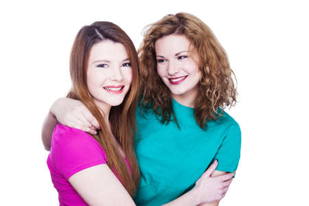 Two young women friends on the white backgroundの写真素材