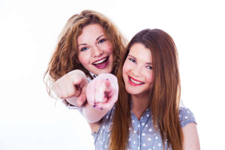 Girls pointing her fingers at you on the white backgroundの写真素材