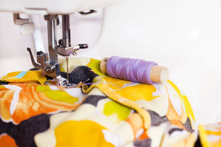 A tailor working on sewing machine from homeの写真素材