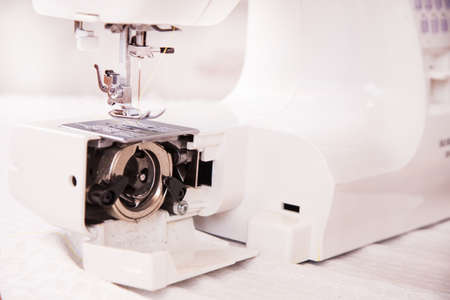 Sewing machine in a closeup with open shuttle
