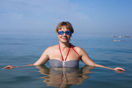 Yoga woman doing exercises at the seafront.の写真素材