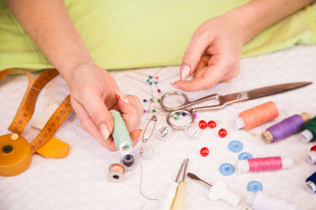 A tailor's working in a workroom choosing stitchingの写真素材