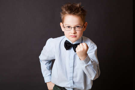 Little boy making angry face and showing fistの写真素材