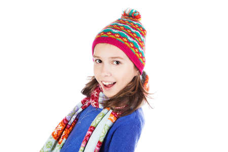 Beautiful little girl in cap and scarf isolated on whiteの写真素材