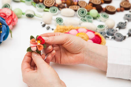 Felting activity - felted flower in woman's handsの写真素材