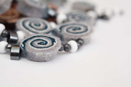 Felting activity - felted necklaces on the whiteの写真素材