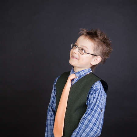 Young funny boy grimacing over the black