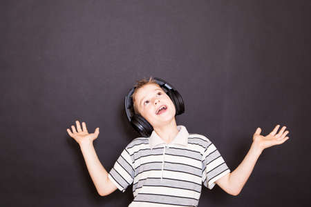 The playful boy  listening to music in headphones