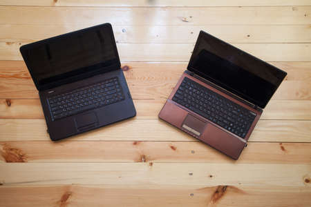 Open laptops on the wooden desk.の写真素材