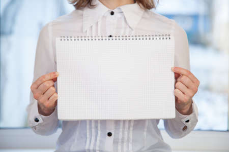 Woman holding blank ring-bound notebookの写真素材
