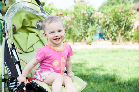 Young pretty girl in a baby carriageの写真素材