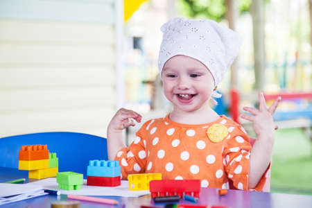 Happy child at the tableの写真素材