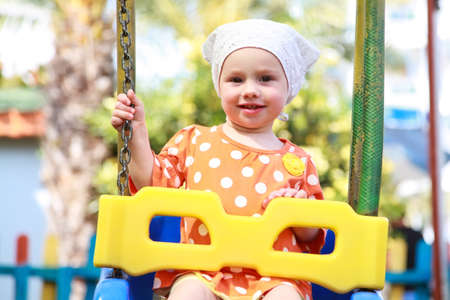 Happy child on the swingsの写真素材