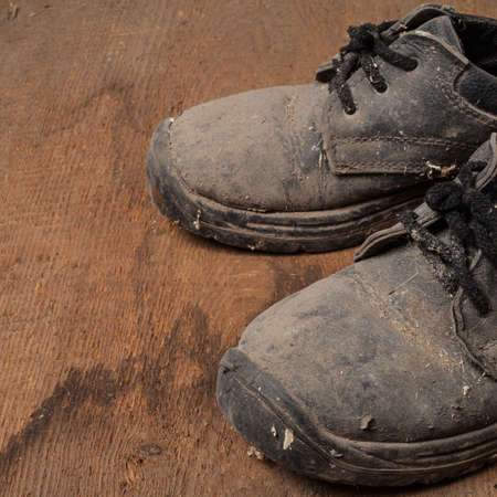 Grunge old boots on  the wood backgroundの写真素材