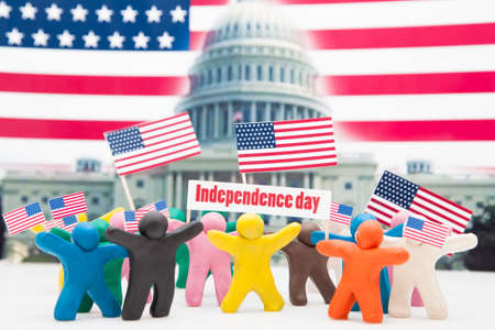 Crowd group of colourful plasticine humans with the USA flags on the white.の写真素材