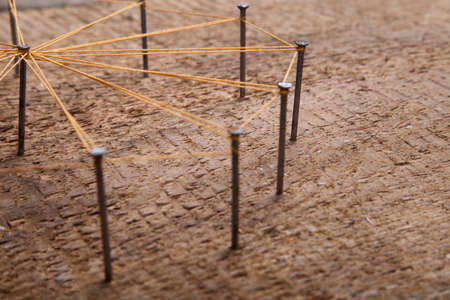 Abstract communication. Nails knotted together with threadの写真素材