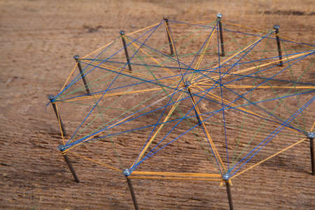 Abstract communication. Nails knotted together with thread