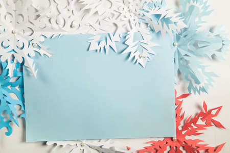Paper snowflakes with empty space for Merry Christmas and Happy New Year greetingsの写真素材