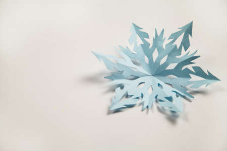 Fine paper snowflake cut out, Christmas background.の写真素材