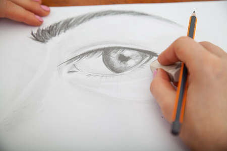 Closeup of drawing human eye at the desk