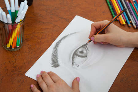 Closeup of drawing human eye at the deskの写真素材