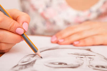 Closeup of drawing mans portrait at the desk