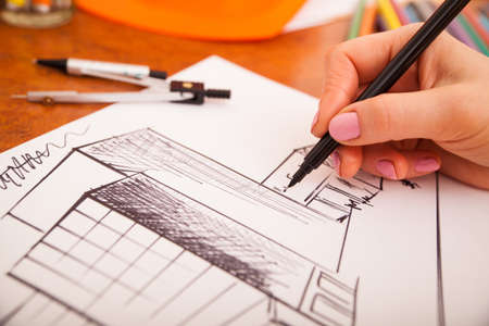 Closeup of drawing building at the desk