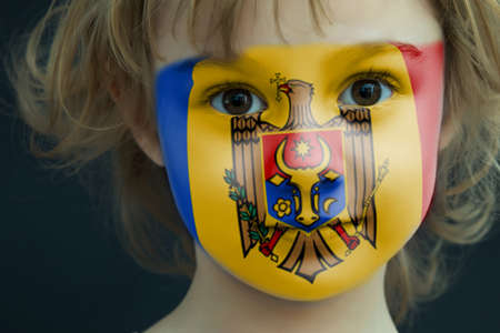 Child with a painted flag of Moldaviaの写真素材