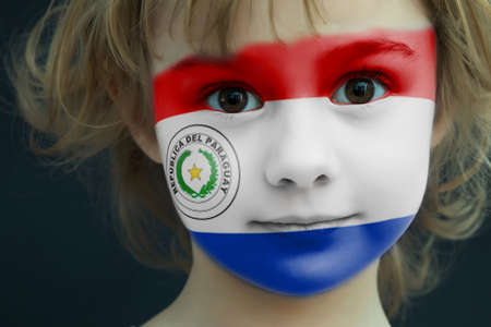 Portrait of a child with a painted Paraguay flagの写真素材