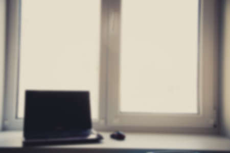 Laptop on the wood table, blur