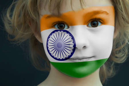 Child with a painted flag of Indiaの写真素材