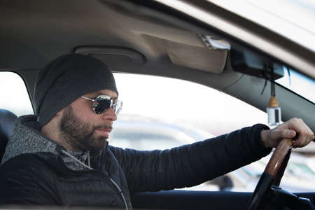 Portrait of man in his car.