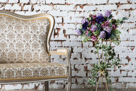 White interior of studio with white and pink flowers for photo shooting.