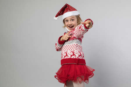 Smiling girl in the winter look on the greyの写真素材