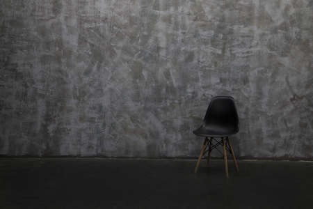 Modern lounge chair against a gray wall.の写真素材