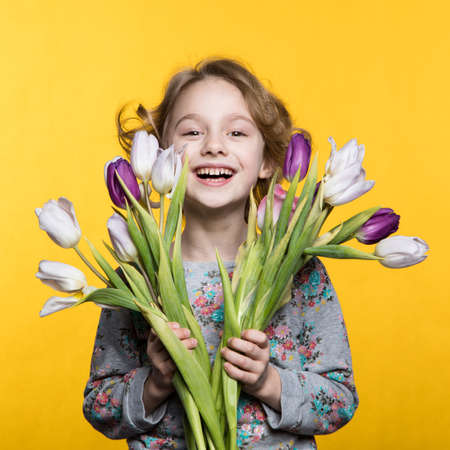 Little girl with a bouquet of tulipsの写真素材